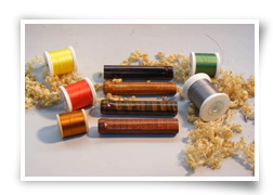 Custom turned reel seat inserts, in descending order: rosewood, maple, and tiger maples.
